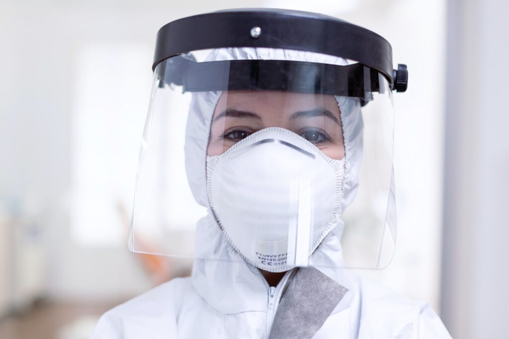 Close up portrait of exhausted doctor with face shield and face mask