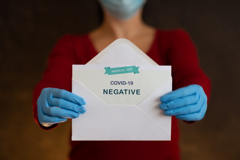 Woman Holding Negative Antigen Detection Test for Covid-19.